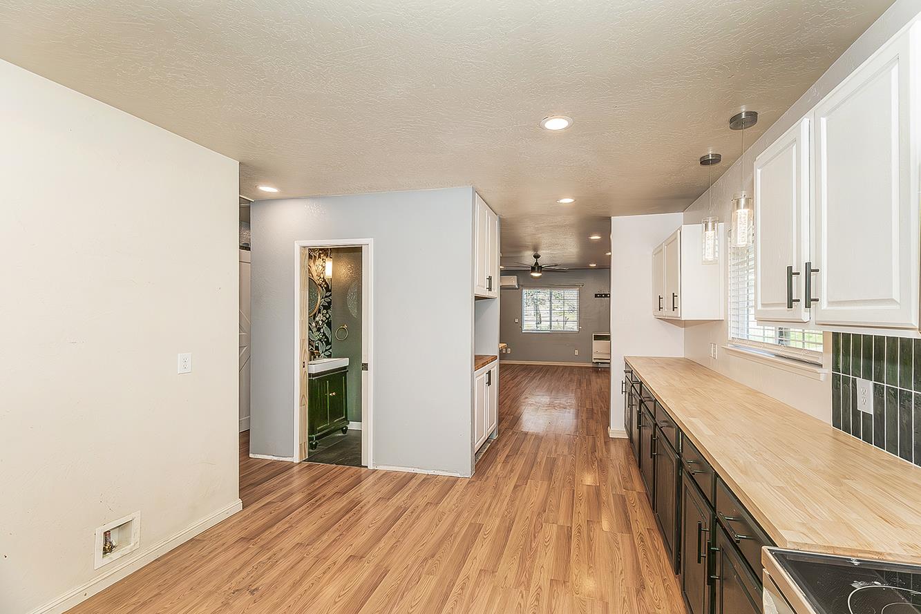 34664 Wilson Road Auberry, CA 93602 - Photo 10 of 35 a view of a kitchen with a sink and wooden floor