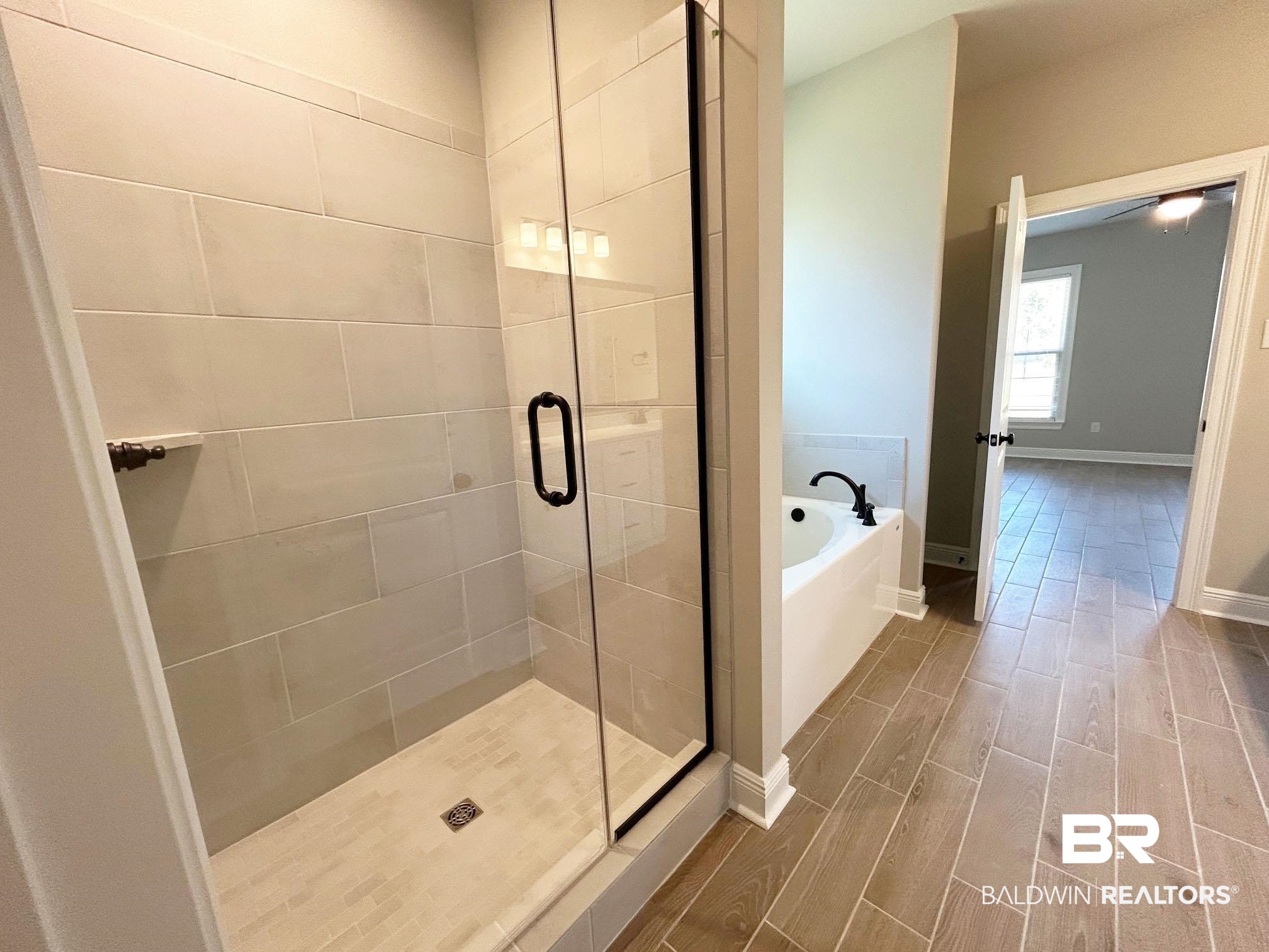 877 Sumter Loop Foley, AL 36535 - Photo 10 of 18 Bathroom with a shower stall, a bath, baseboards, and wood finish floors