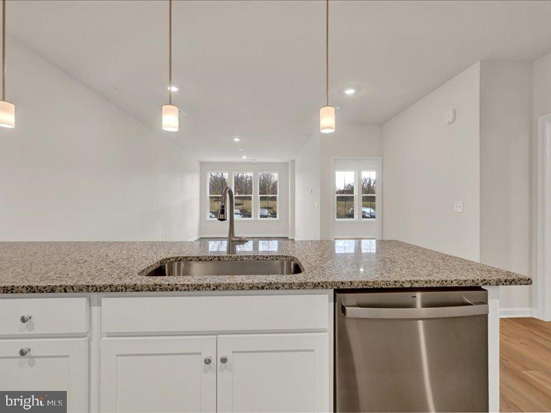 4005 Seaside Alder Road, Unit D Bowie, MD 20720 - Photo 10 of 41 a kitchen with granite countertop cabinets and a sink