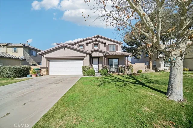 a front view of a house with a garden and plants