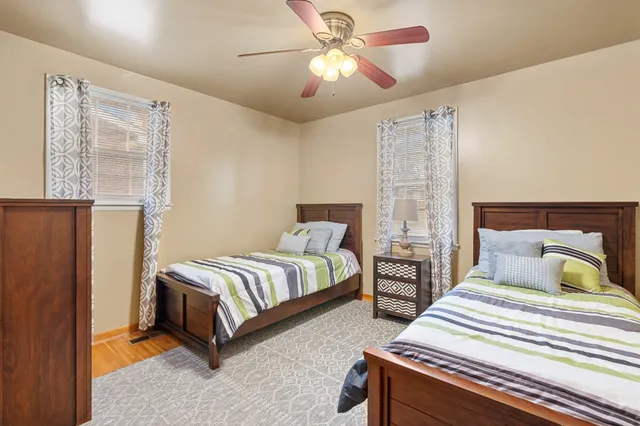 a bedroom with two beds and a chandelier