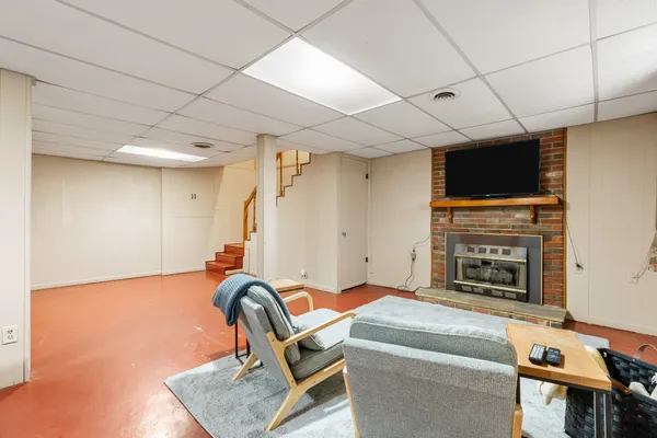 a living room with furniture a flat screen tv and a fireplace