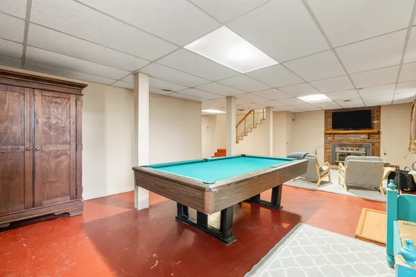 a room with furniture pool table flat screen tv and a table