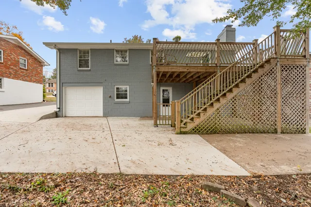 a view of a house with wooden fence