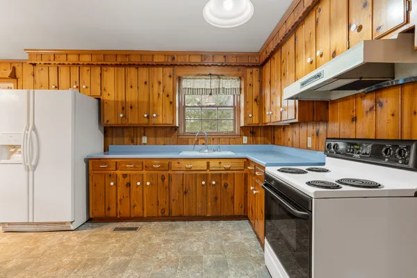 a kitchen with stainless steel appliances granite countertop a refrigerator and a stove