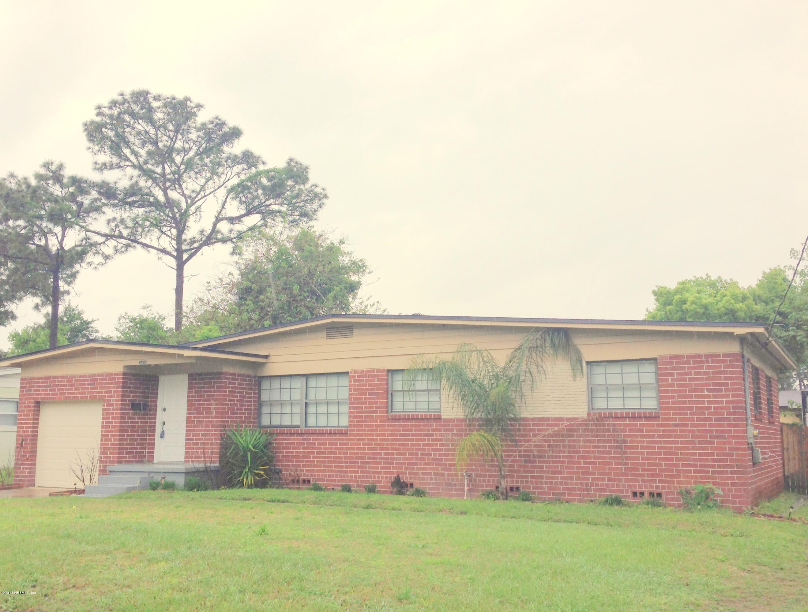 3436 Rogero Road Jacksonville, FL 32277 - Photo 1 of 6 front view of house with a yard