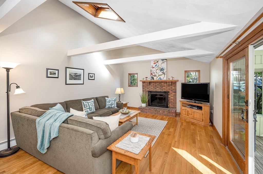 16 Haystack Road Reading, MA 01867 - Photo 13 of 42 a living room with furniture and a fireplace