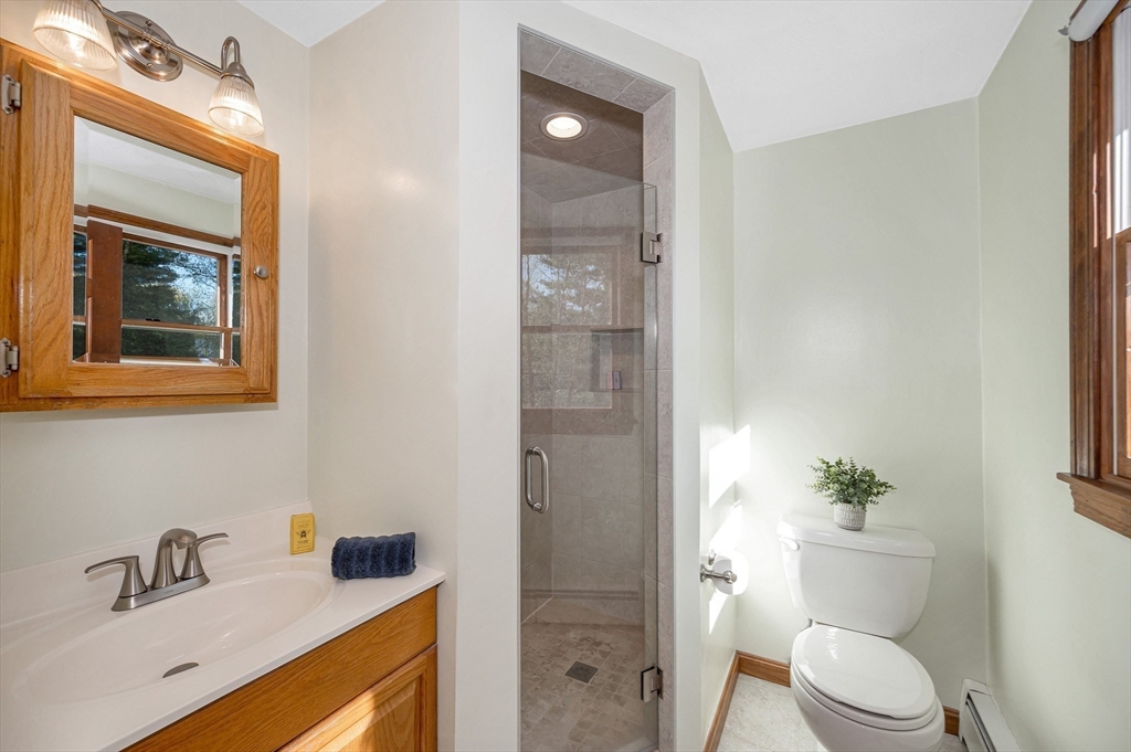 16 Haystack Road Reading, MA 01867 - Photo 18 of 42 a bathroom with a granite countertop sink toilet and shower