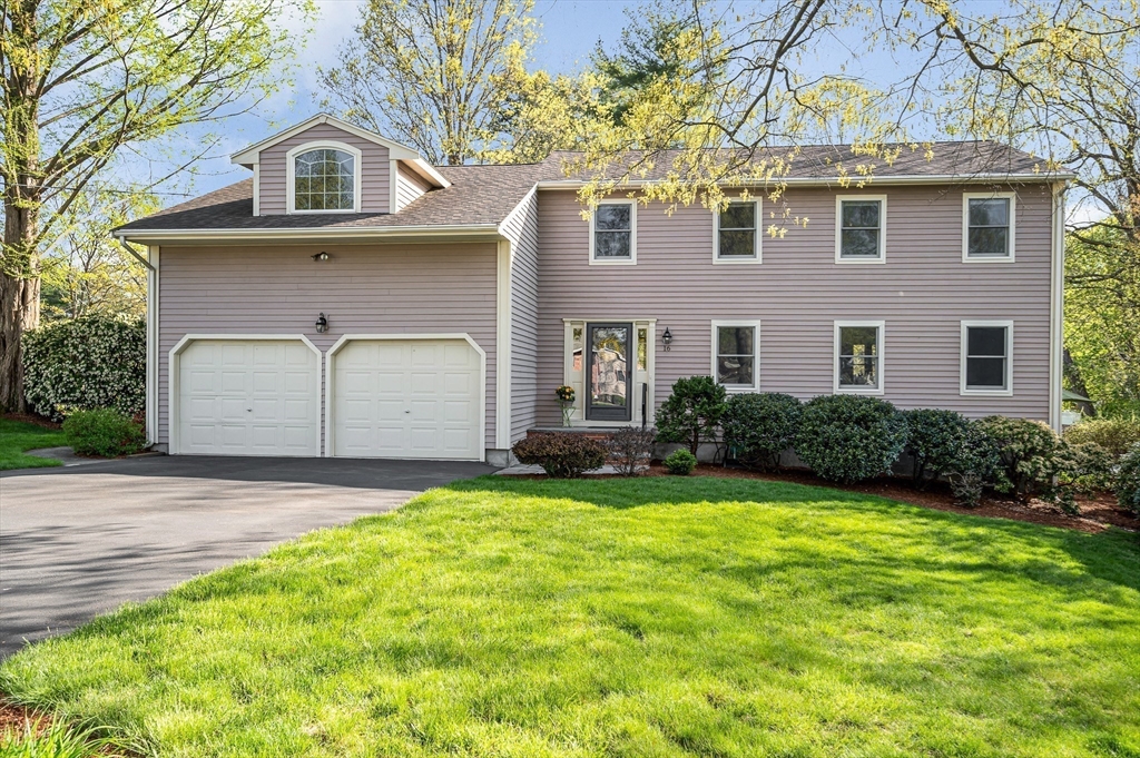 16 Haystack Road Reading, MA 01867 - Photo 2 of 42 a front view of a house with a yard and garage