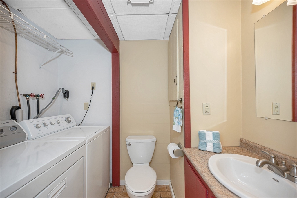 16 Haystack Road Reading, MA 01867 - Photo 29 of 42 a bathroom with a sink a toilet and a mirror