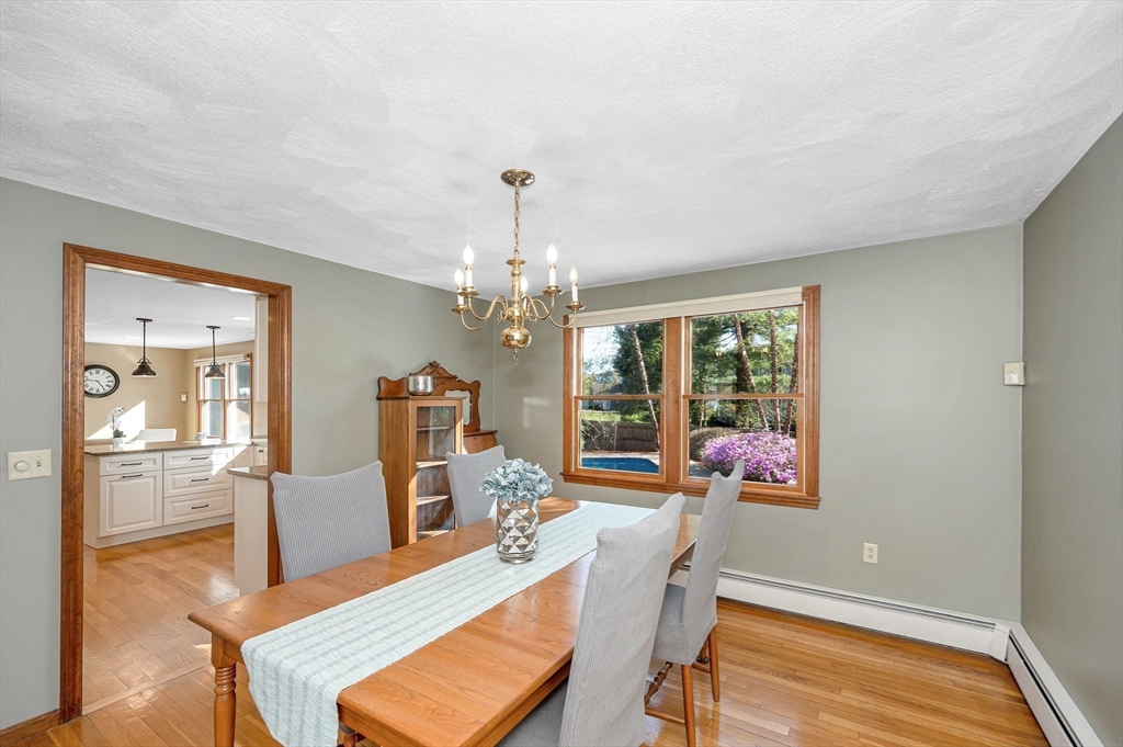 16 Haystack Road Reading, MA 01867 - Photo 6 of 42 a living room with furniture and a chandelier
