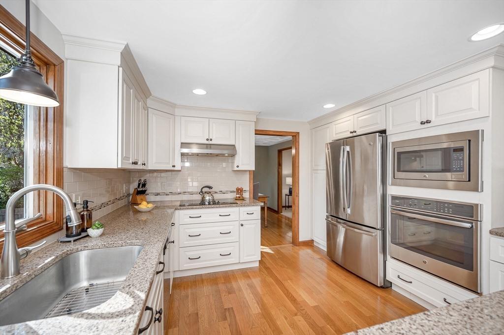 16 Haystack Road Reading, MA 01867 - Photo 9 of 42 a kitchen with stainless steel appliances granite countertop a refrigerator sink and stove