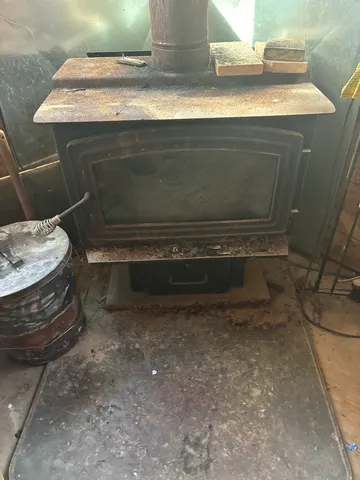 a view of a field with large trees