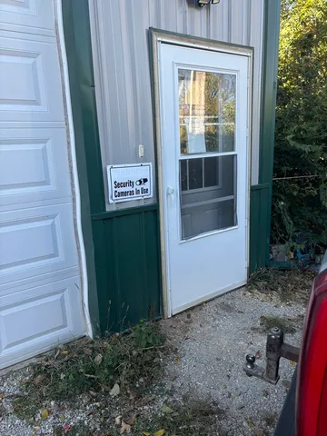 a view of a yard with plants and trees