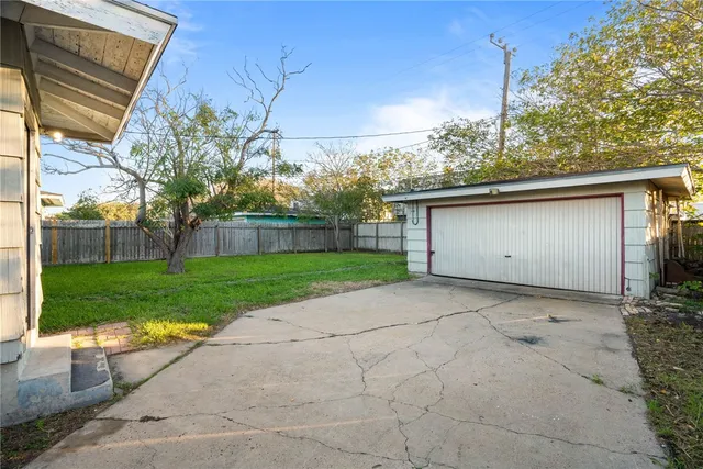 a view of backyard of house with green space