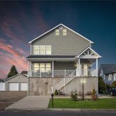 a front view of a house with a yard and table and chairs