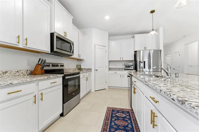 a kitchen with stainless steel appliances granite countertop a sink and cabinets