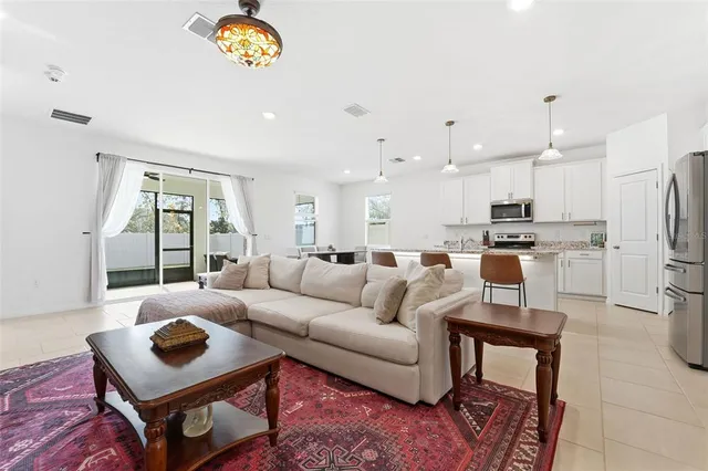 a living room with furniture and a chandelier