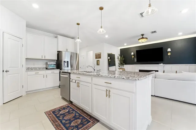 a kitchen with white cabinets and white appliances