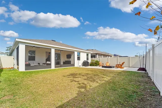 a large house with a big yard and large trees