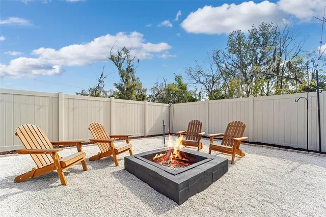 a backyard of a house with table and chairs