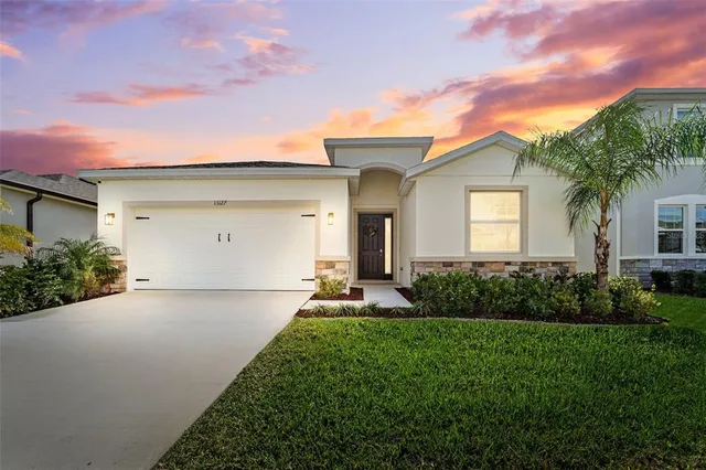 a front view of house with yard and green space