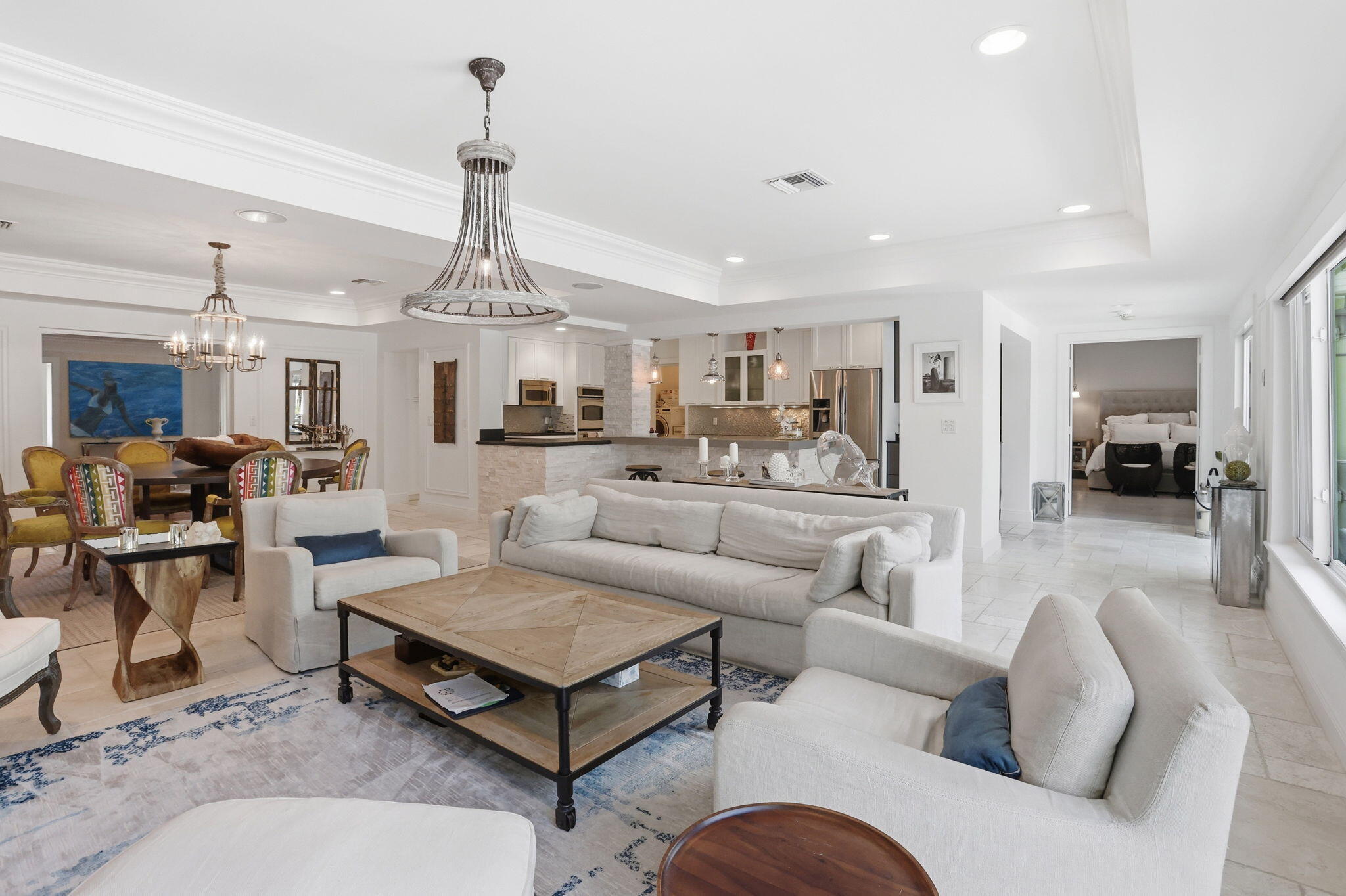 309 Northeast 8th Avenue Delray Beach, FL 33483 - Photo 12 of 43 a living room with furniture kitchen view and a chandelier