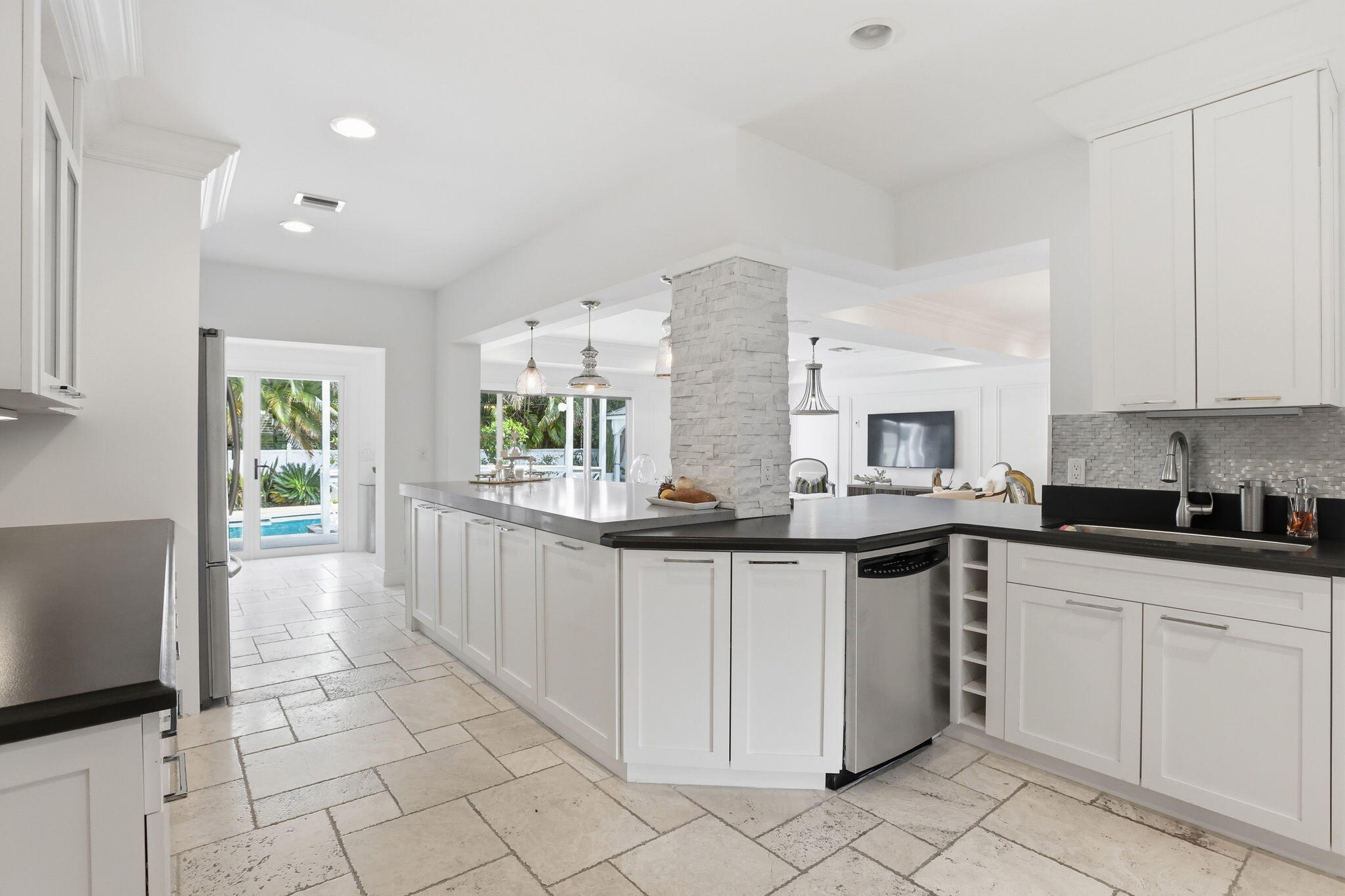 309 Northeast 8th Avenue Delray Beach, FL 33483 - Photo 14 of 43 a kitchen with white cabinets a sink and appliances