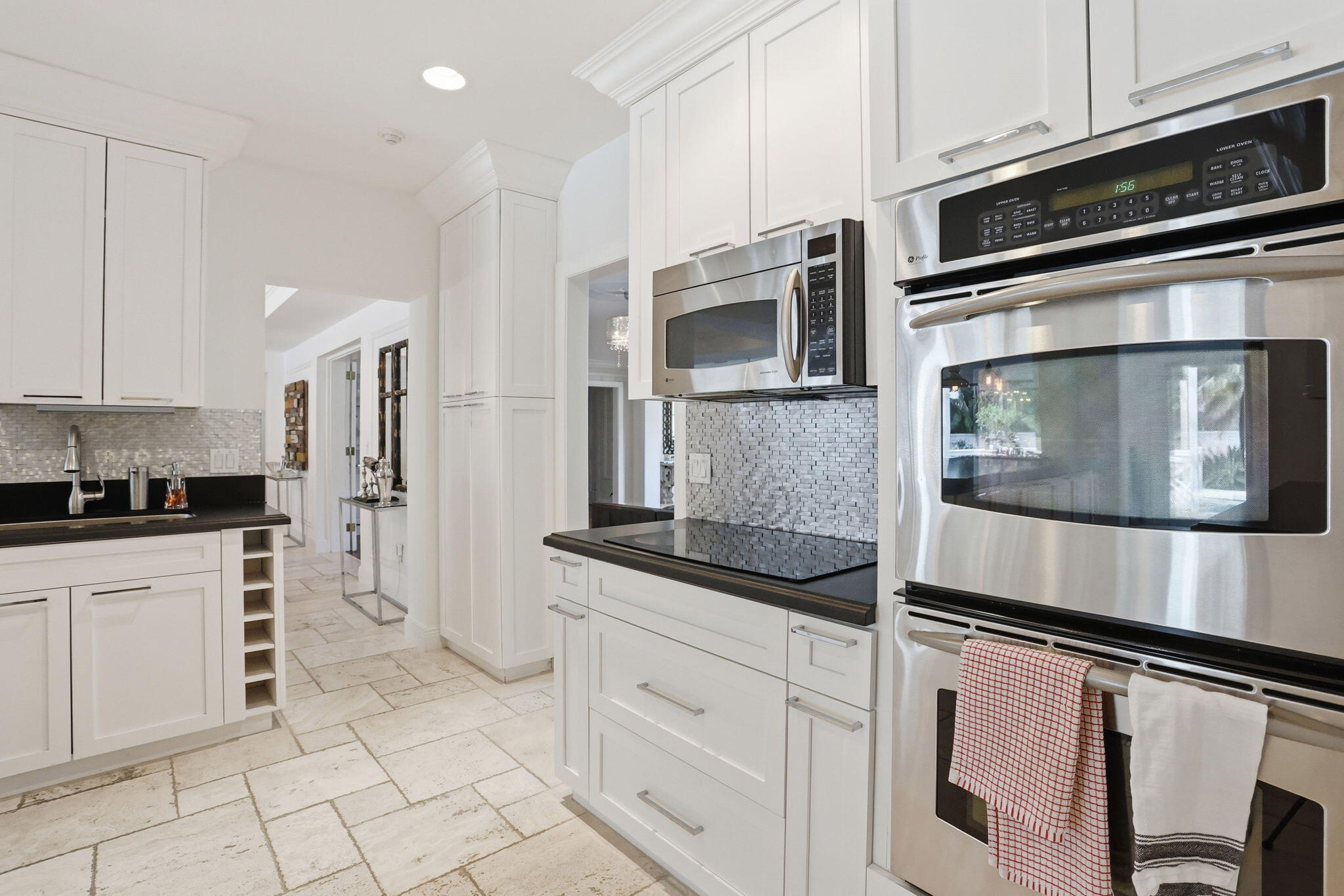309 Northeast 8th Avenue Delray Beach, FL 33483 - Photo 15 of 43 a kitchen with stainless steel appliances granite countertop a stove microwave and cabinets