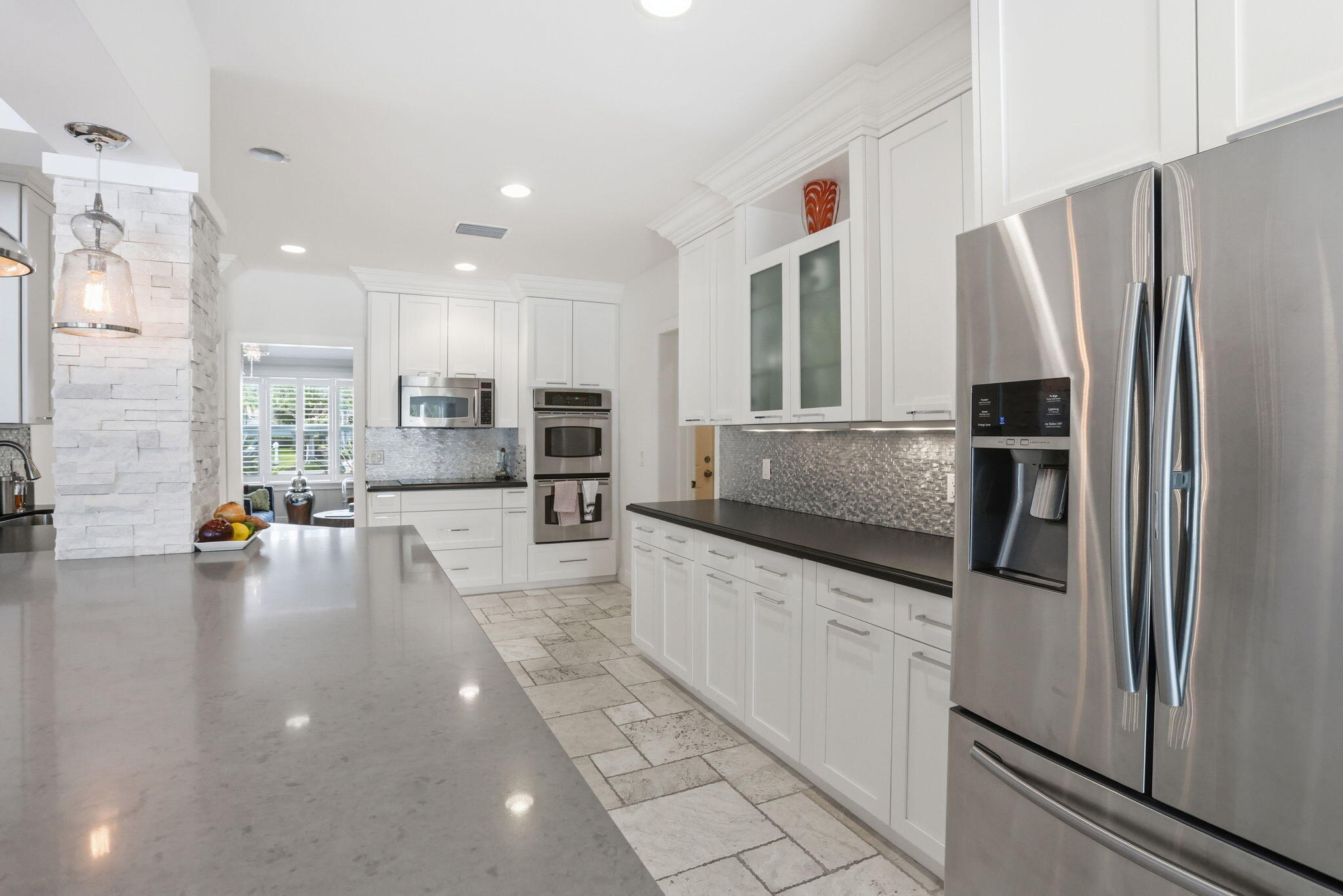 309 Northeast 8th Avenue Delray Beach, FL 33483 - Photo 17 of 43 a kitchen with stainless steel appliances a refrigerator a stove a sink a oven and white cabinets