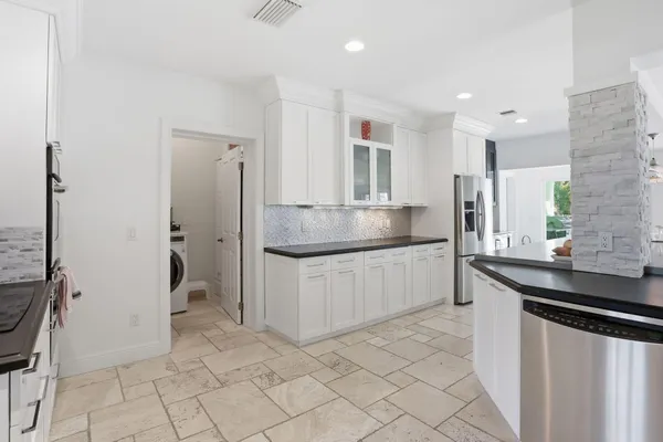 a kitchen with stainless steel appliances granite countertop a sink and a stove
