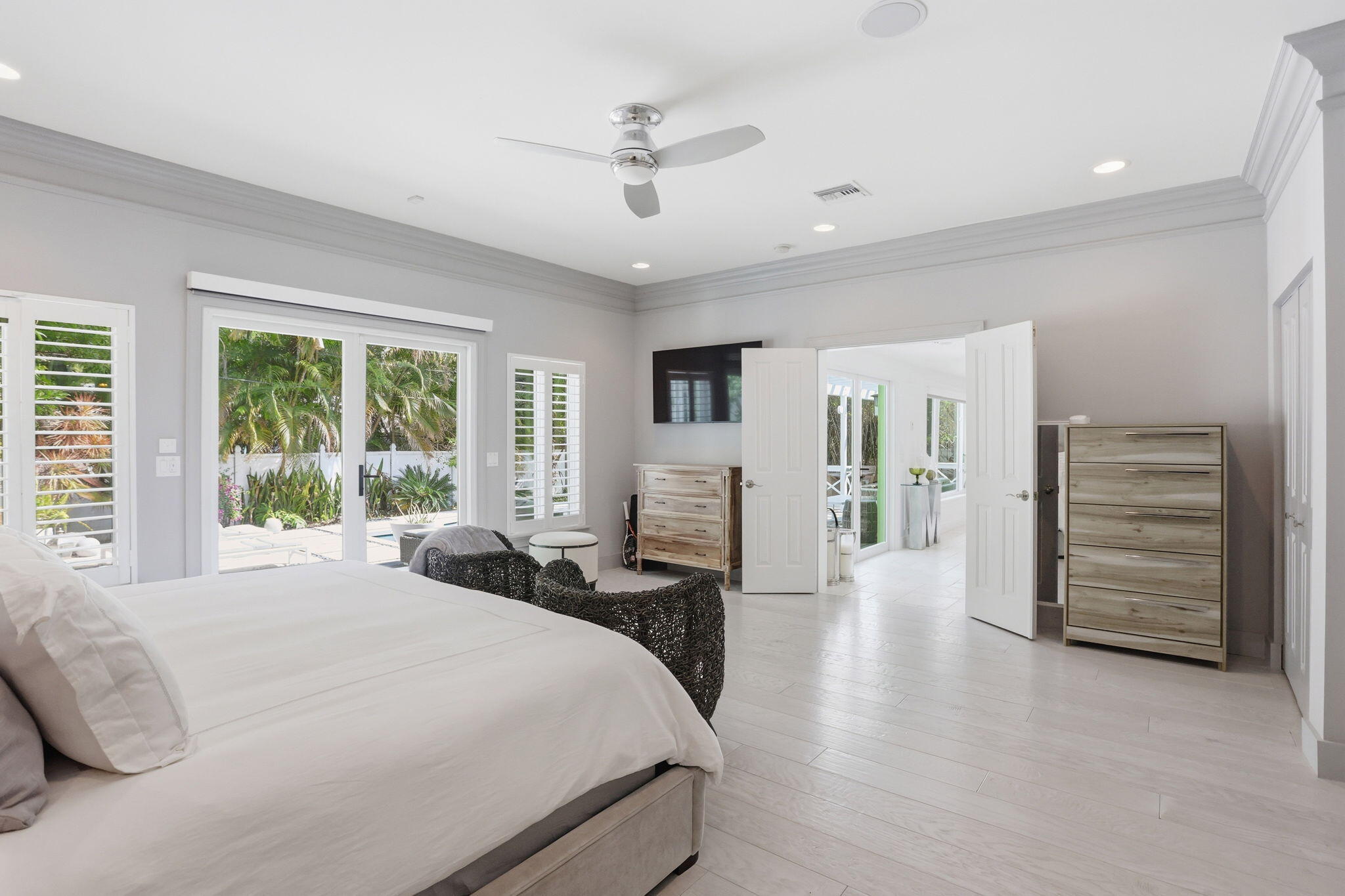 309 Northeast 8th Avenue Delray Beach, FL 33483 - Photo 20 of 43 a spacious bedroom with a bed a dresser and a large window