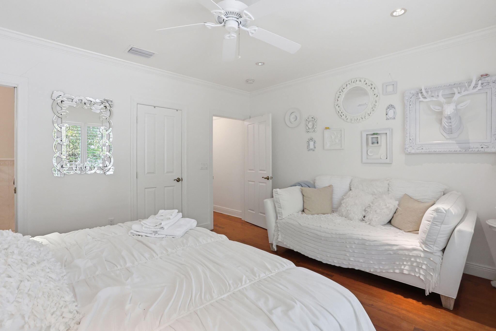 309 Northeast 8th Avenue Delray Beach, FL 33483 - Photo 24 of 43 a bedroom with a white bed and a couch