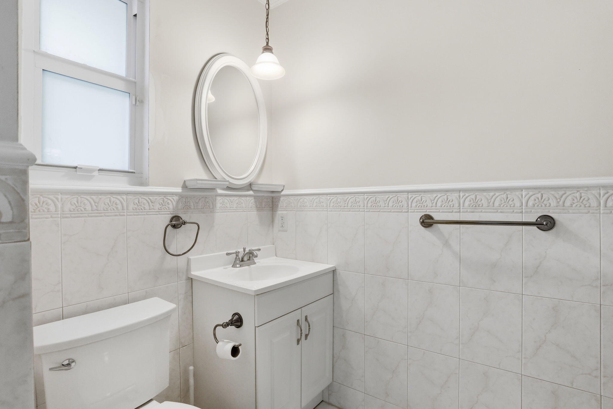 309 Northeast 8th Avenue Delray Beach, FL 33483 - Photo 27 of 43 a bathroom with a sink a toilet and a mirror