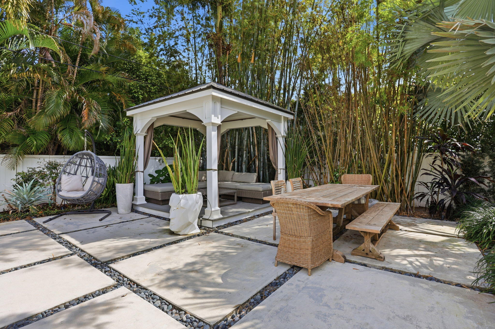 309 Northeast 8th Avenue Delray Beach, FL 33483 - Photo 36 of 43 a view of a patio with table and chairs potted plants and large tree