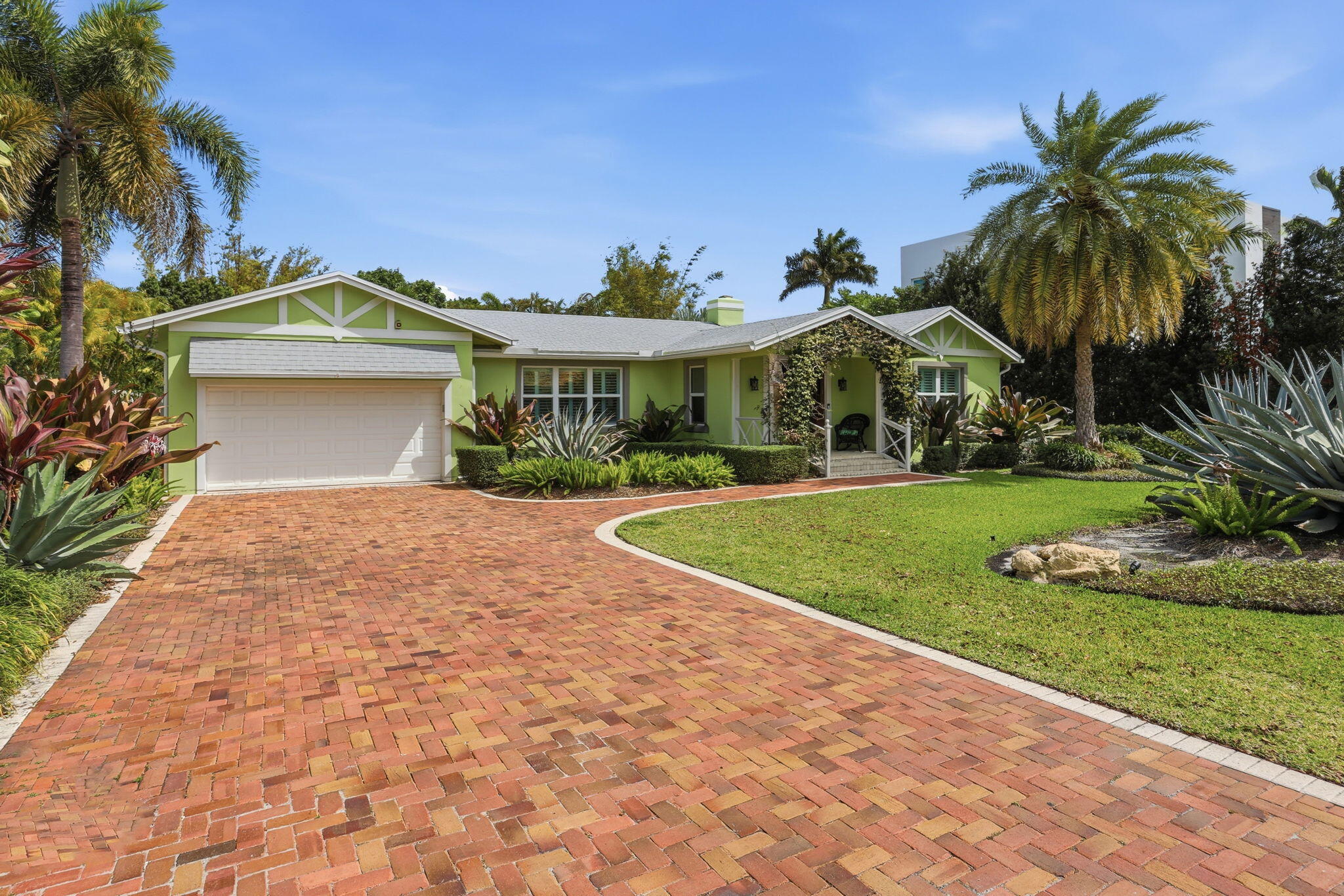 309 Northeast 8th Avenue Delray Beach, FL 33483 - Photo 42 of 43 a front view of a house with a yard and potted plants