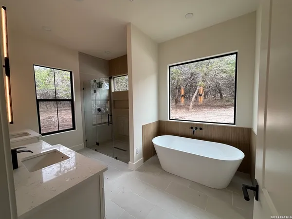 a spacious bathroom with a tub and sink