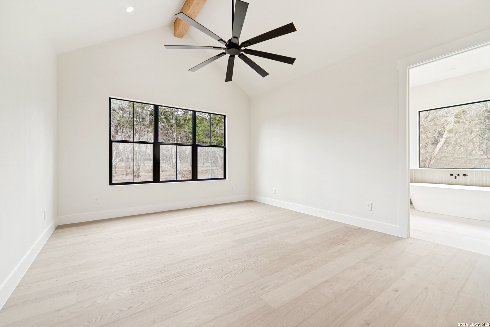 129 Aermotor Lane Boerne, TX 78006 - Photo 16 of 25 an empty room with chandelier fan and windows