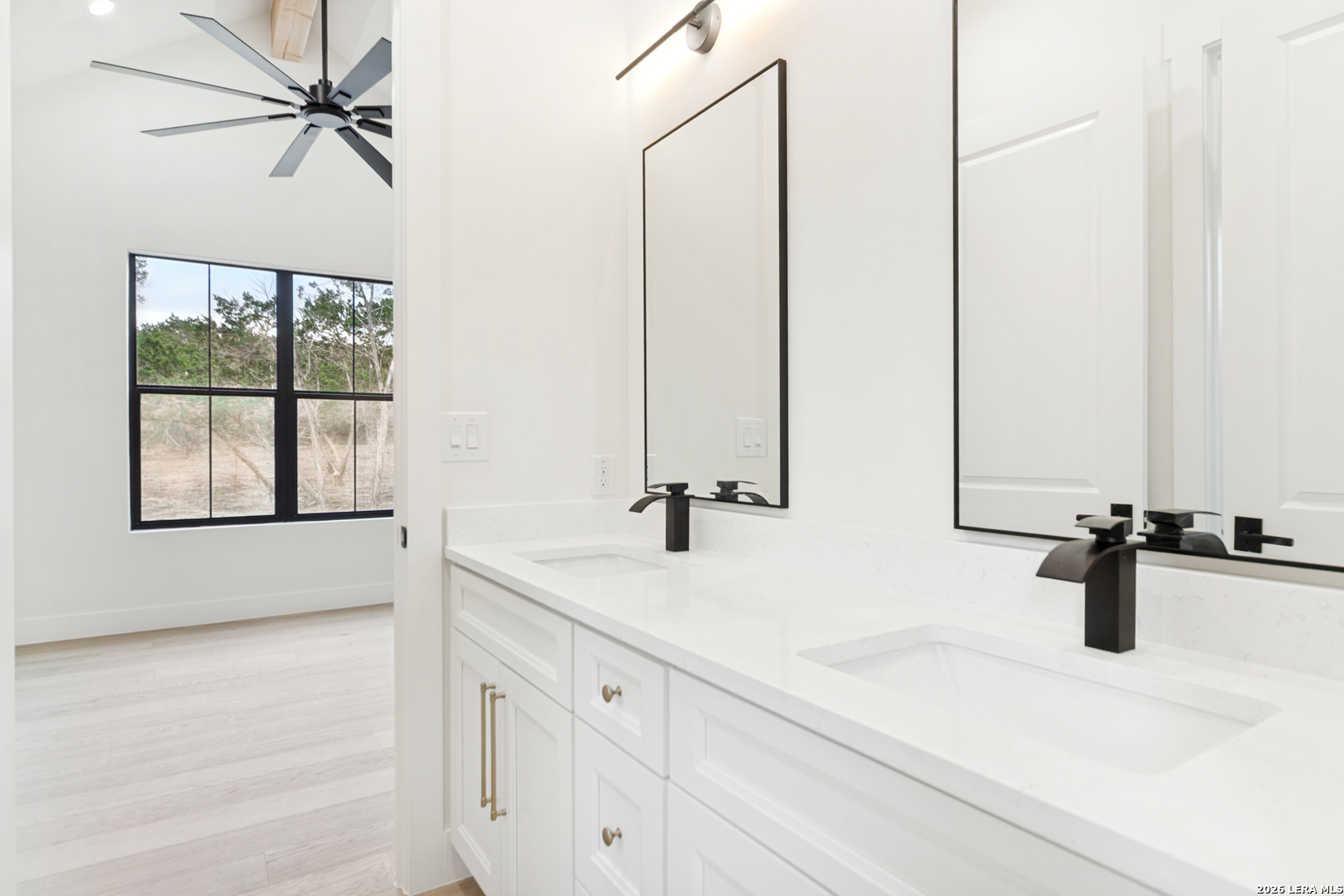 129 Aermotor Lane Boerne, TX 78006 - Photo 22 of 25 a bathroom with a sink and a window