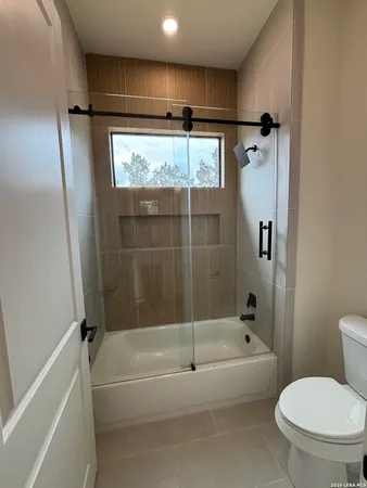 a bathroom with a shower and a toilet