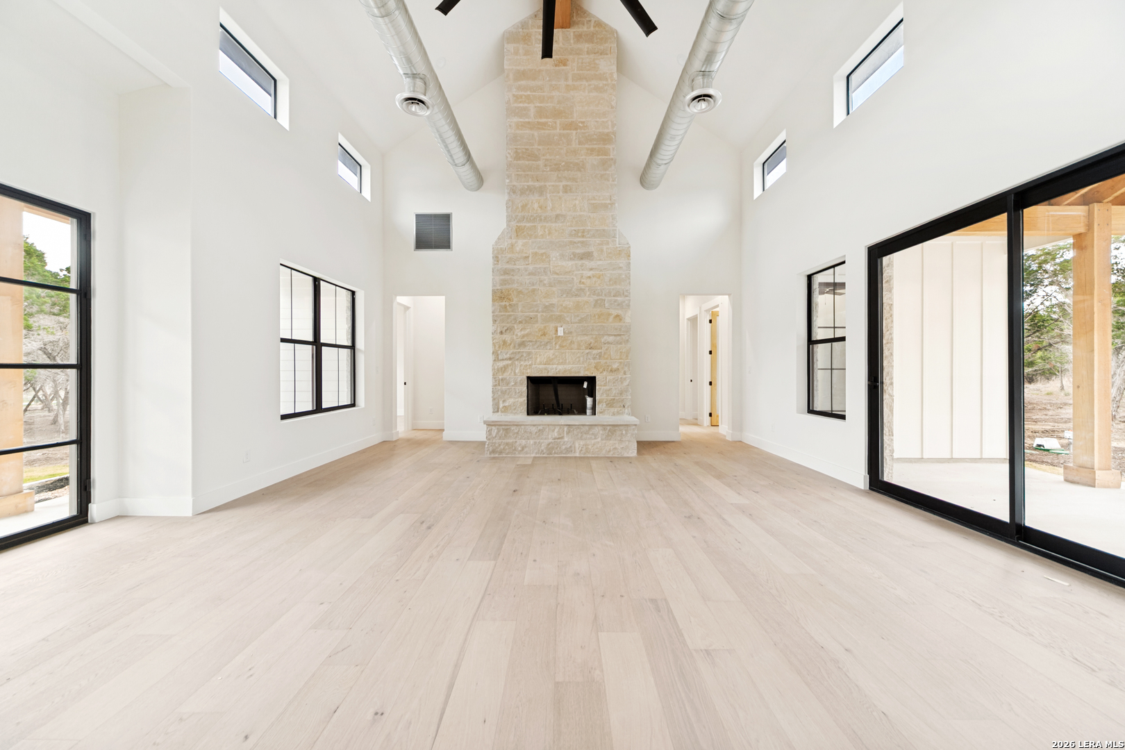 129 Aermotor Lane Boerne, TX 78006 - Photo 6 of 25 a view of empty room with floor to ceiling window and fireplace