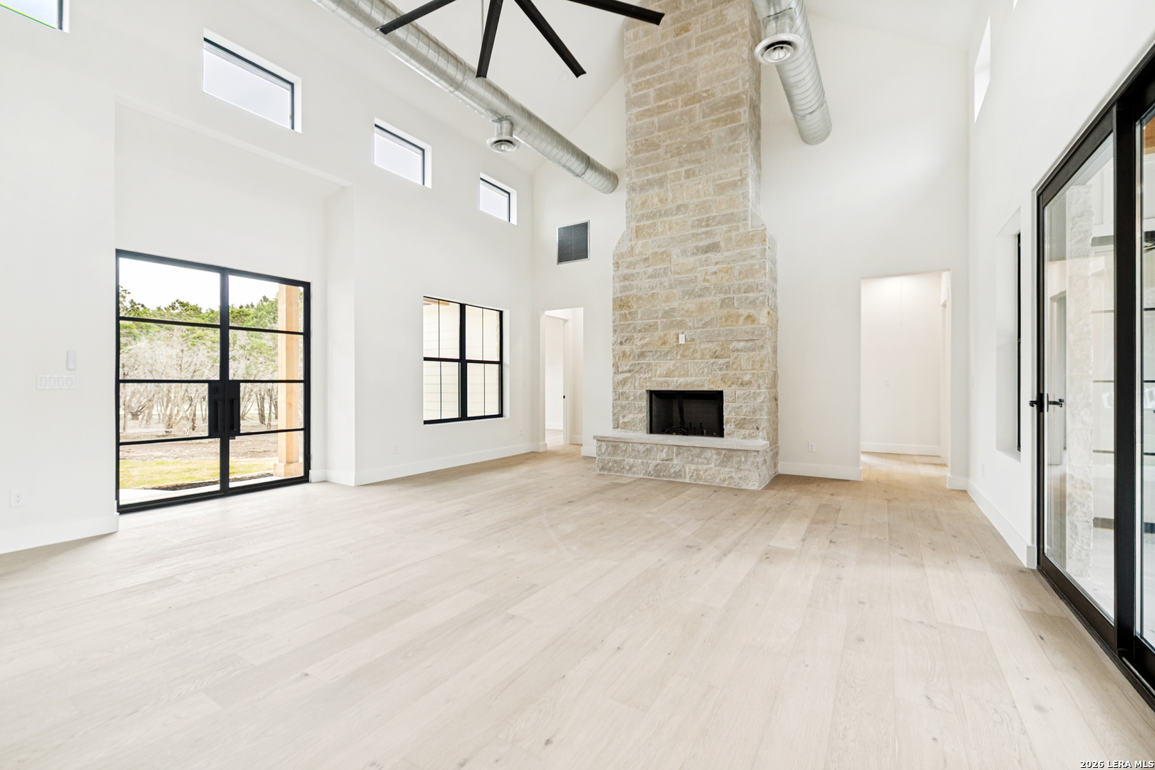 129 Aermotor Lane Boerne, TX 78006 - Photo 7 of 25 a view of an empty room with a fireplace and a window