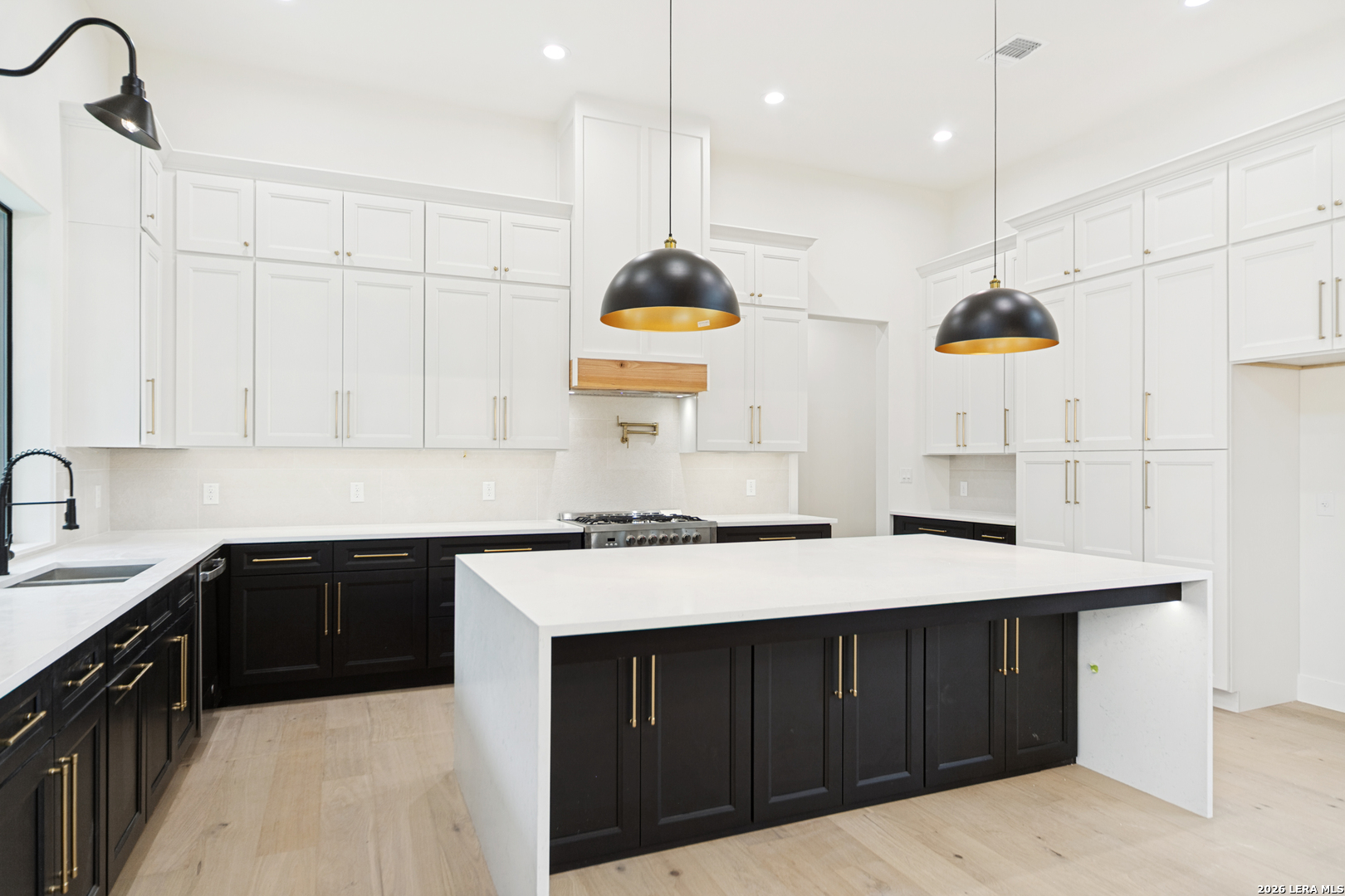 129 Aermotor Lane Boerne, TX 78006 - Photo 10 of 25 a kitchen with kitchen island granite countertop a sink a counter space and cabinets