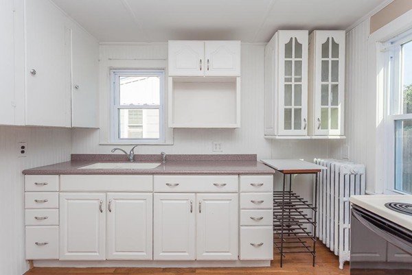 9 Blueberry Road Wareham, MA 02558 - Photo 3 of 23 a kitchen with white cabinets and window