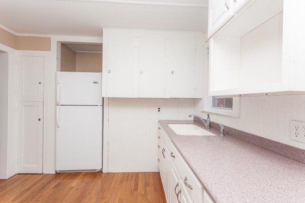 9 Blueberry Road Wareham, MA 02558 - Photo 5 of 23 a kitchen with a sink and a refrigerator