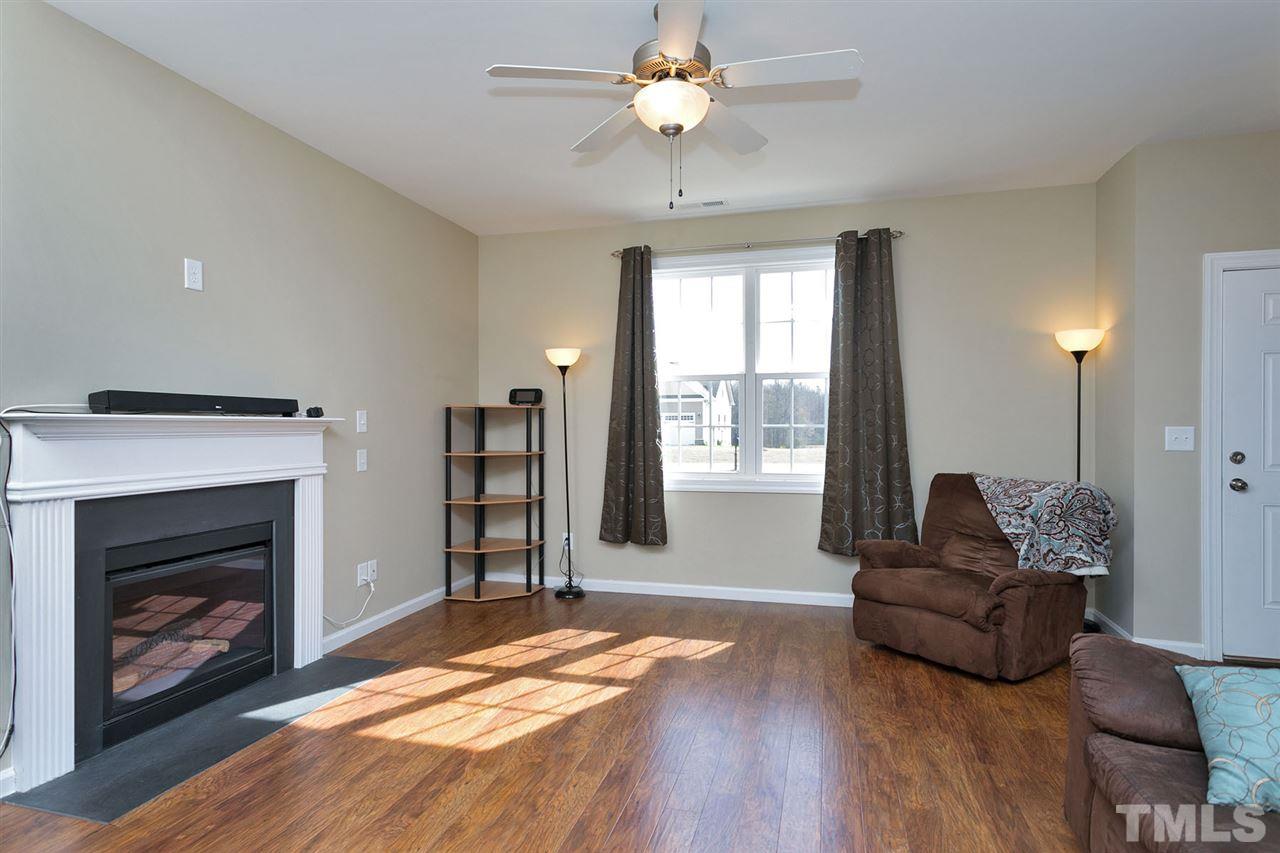7998 Creech Road Middlesex, NC 27557 - Photo 2 of 18 Bright and light family room features hardwood floors and gas log fireplace.