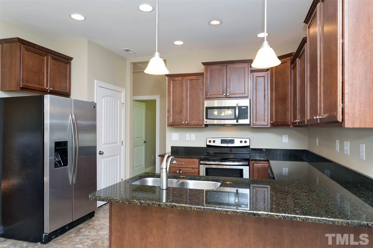 7998 Creech Road Middlesex, NC 27557 - Photo 6 of 18 Granite counter tops and staggered height cabinets. Plenty of cabinets, counter space and great size pantry.