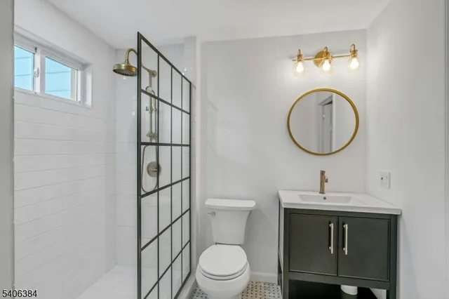 a bathroom with a toilet a sink and a mirror