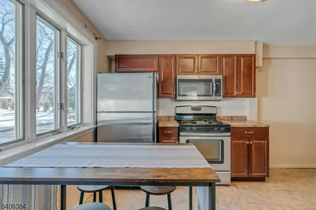 a kitchen with a stove a sink and a refrigerator