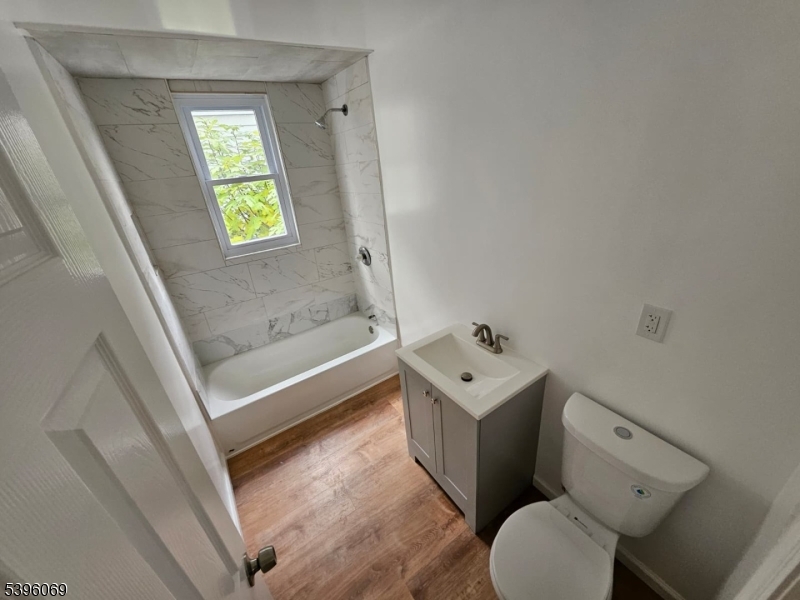 518 East 23rd Street, Unit 1F Paterson, NJ 07514 - Photo 2 of 4 a bathroom with a sink toilet and shower